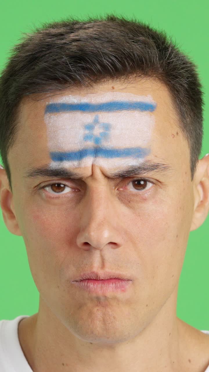 Serious man with a israeli flag painted on the face