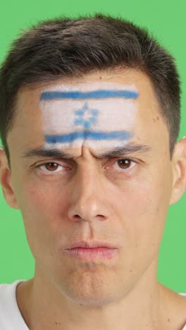 serious man with a israeli flag painted on the face