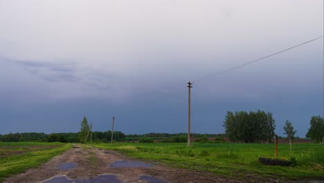 Timelapse-of-dramatic-dark-storm-clouds-move-in-sky-with-wet-road,-Latvia