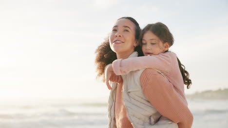 mother, girl and piggyback at beach