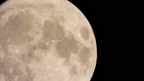 bright and detailed close up shot of the full moon, shining on a pitch black night sky