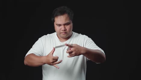 asian man showing his trick with cards, cardistry on black background