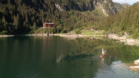 Aerial-of-man-supping-on-lake