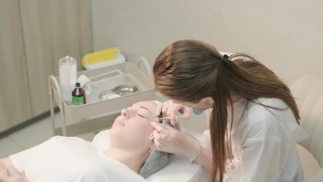 cosmetologist performing facial injection procedure