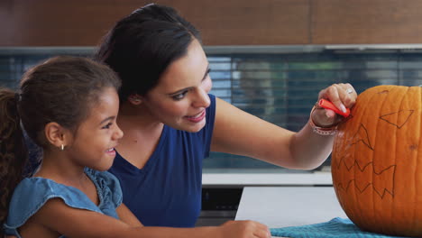 Mother-And-Daughter-Carving-Halloween-Lantern-From-Pumpkin-At-Home