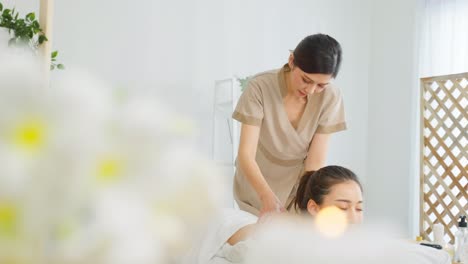 woman receiving a back massage at a spa