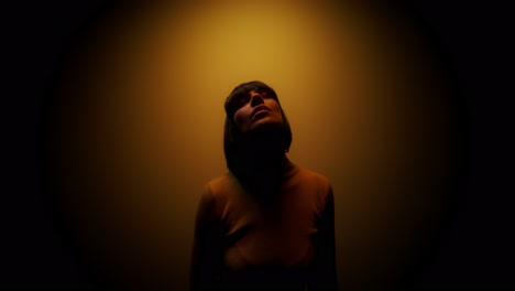 woman in a warm, focused studio light