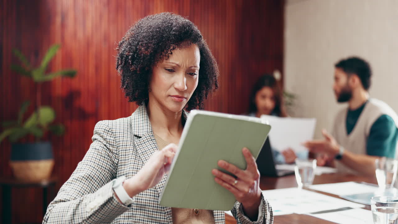 Businesswoman using a tablet during a meeting