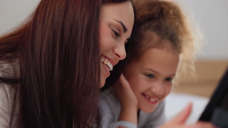 Tablet,-laughing-and-mother-with-child-on-bed