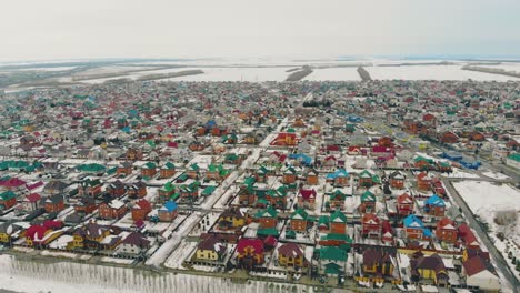 cottage complex with colorful houses against snow field