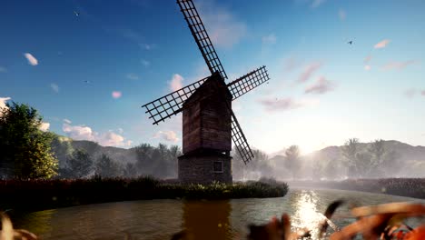 molino de viento tradicional del pueblo de pie cerca del estanque contra el fondo de las montañas y las nubes al amanecer. animación 3d realista en bucle.