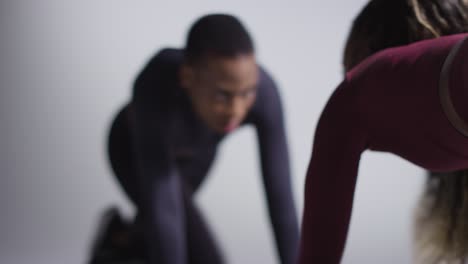 studio shot of two women wearing gym fitness clothing facing each other exercising 8