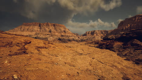 expansive view of rocky desert landscape under dramatic cloudy sky