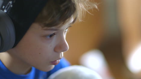 profile-of-young-boy-wearing-headphones-on-a-laptop