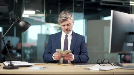 business employee man in office counts the cash money in an envelope, clerk corrupt received a bribe. illegal unethical gift or lobbying