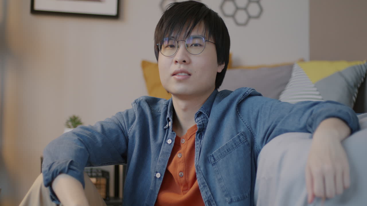 Young man sitting in a room