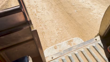 pickup truck travels along a dusty dirt road