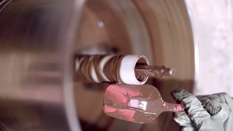 crop person with spatula mixing chocolate in machine