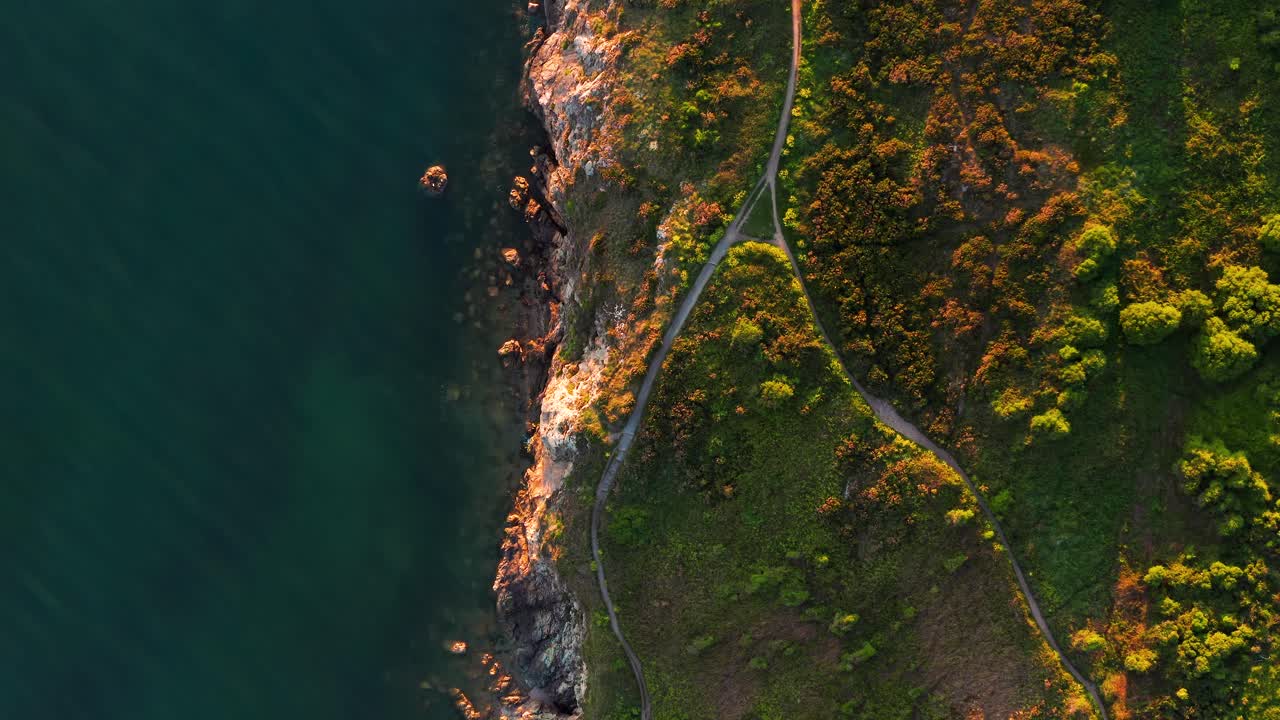 Aerial View of Howth’s Rocky Coastal Cliffs and Calm Sea During Golden Sunset