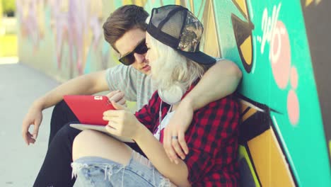 affectionate hipster urban couple relaxing in town