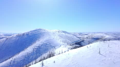 bird's eye flight over snowy mountains 4k drone