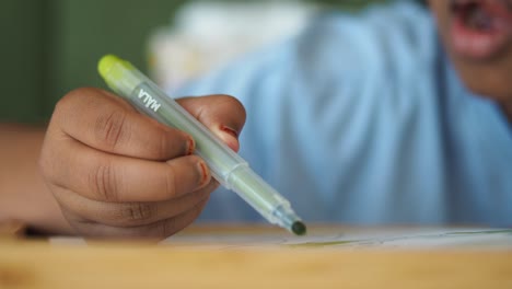 child coloring with marker
