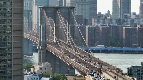 Aerial-reveal-of-Brooklyn-Bridge-connecting-Manhattan-and-Brooklyn,-New-York-over-the-East-River