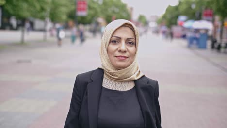 beautiful middle adult arab woman walking down street