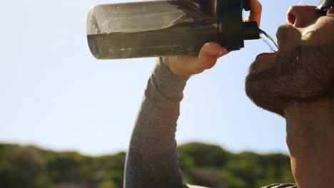 triathlete man drinking water on a sunny day