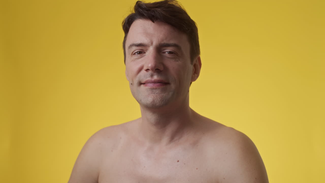 Smiling Middle-aged Caucasian Man in Yellow Background