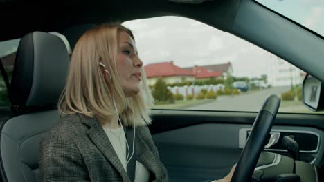 woman driving a car and listening to music