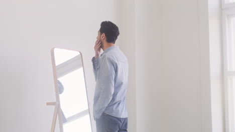 Dark-Haired-Man-Staring-At-Himself-In-The-Mirror