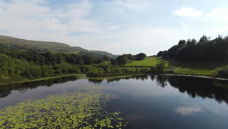 Fast-Fpv-shot-of-the-reflection-of-the-sky-on-a-lake-in-Wales