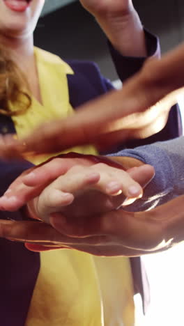 businesspeople forming hands stack