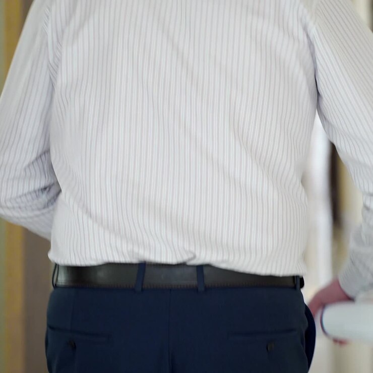 an employee with papers is running along the corridor to his workplace. Late to office