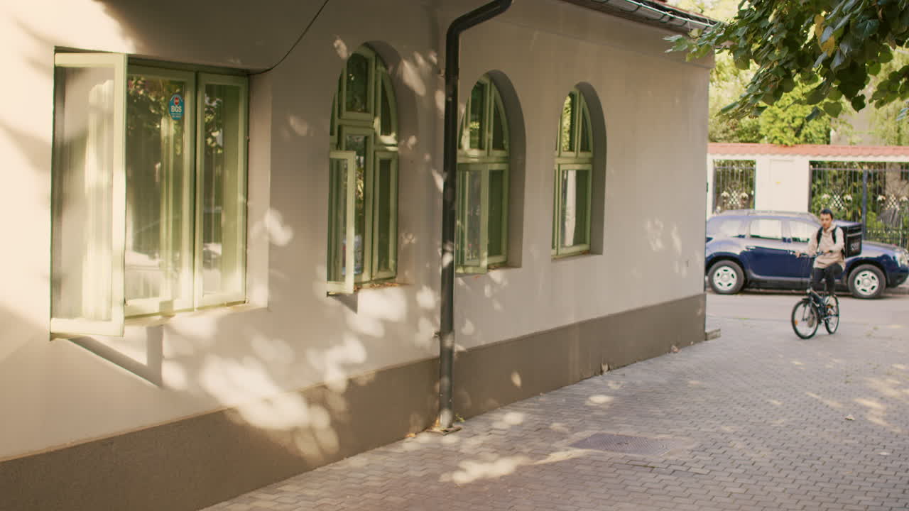 Woman on Bicycle Delivering Food in Urban Setting