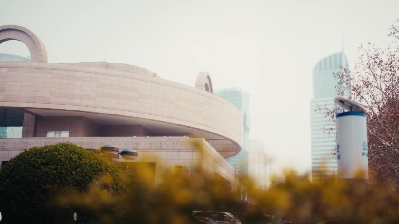 Uma vista da arquitetura distinta com topo redondo e base quadrada do Museu de Xangai na Praça do Povo, Distrito de Huangpu, contrastada com torres de vidro contemporâneas em um dia nublado