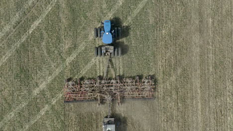 directly above tractor with seeding machine, efficient sowing of land