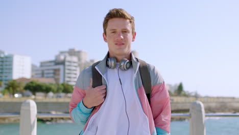 headphones, smile and face of man at beach