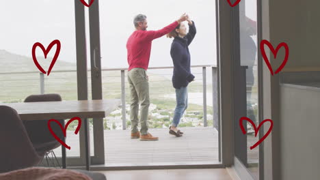 Animation-of-hearts-over-diverse-couple-dancing-on-balcony