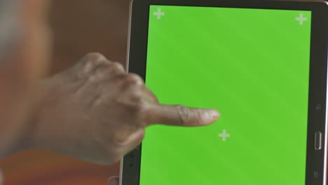 black hand tapping, and scrolling on a digital tablet green screen display