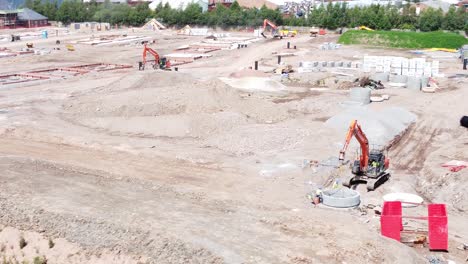 reino unido ciudad desarrollo de viviendas excavadores trabajo fundación sitio de construcción vista aérea izquierda lenta órbita baja