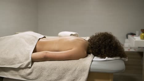 woman enjoying a relaxing massage therapy session in a tranquil spa setting