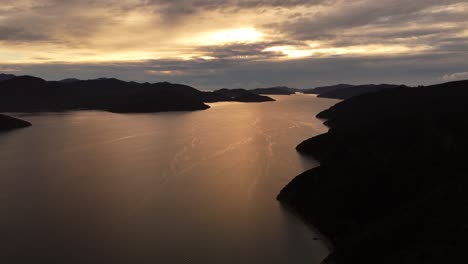 Aerial wide shot of picton area in New Zealand with bay and silhouette of islands. Coastline of island during mystic cloudy sunset time. Panorama. Quiet and peaceful atmosphere