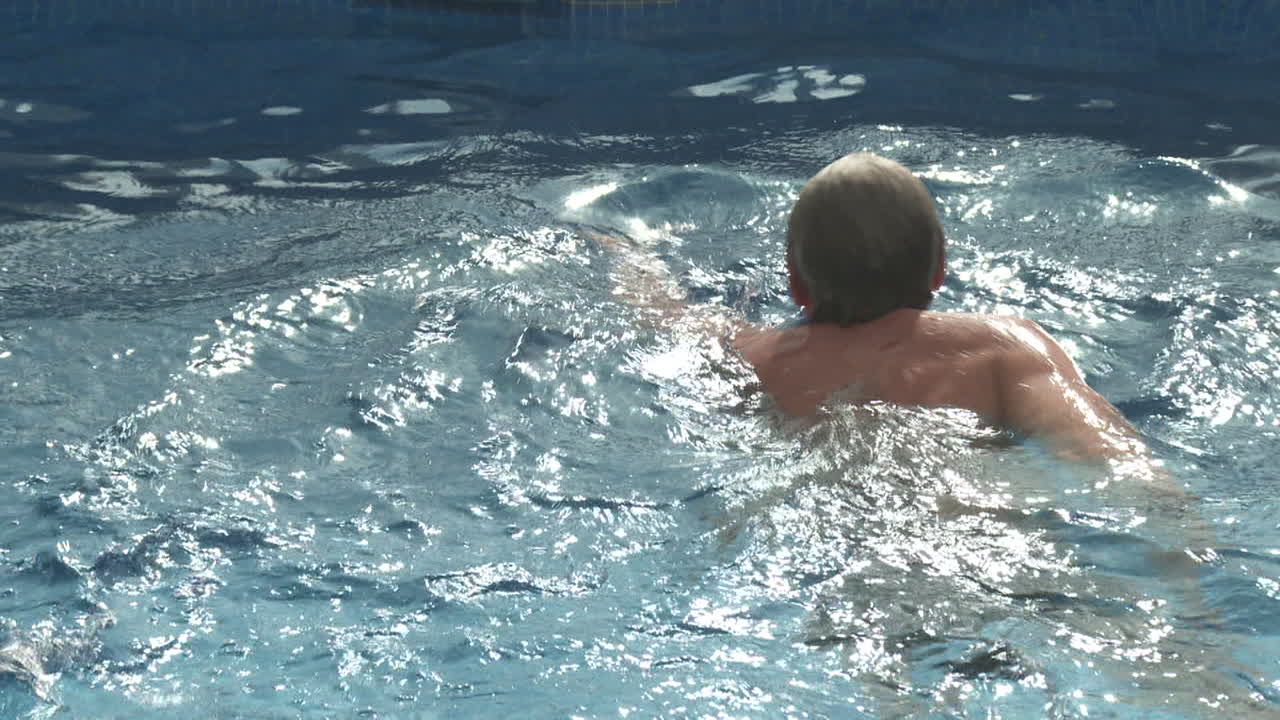 Person Swimming in a Swimming Pool