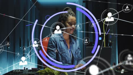 Animation of network of connections with people icons over african american woman using laptop