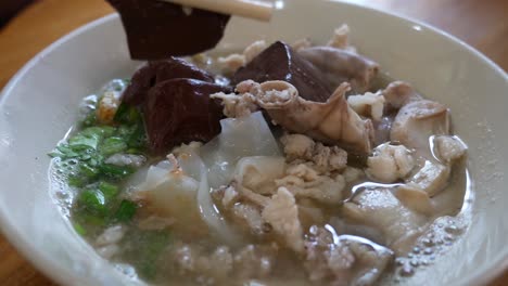 Nahaufnahmen-Von-Schweineblutwurst-Und-Schweinefleischsuppe,-Beliebtes-Thailändisches-Frühstück,-Das-Sowohl-Im-Restaurant-Als-Auch-Auf-Dem-Straßenmarkt-Verkauft-Wird