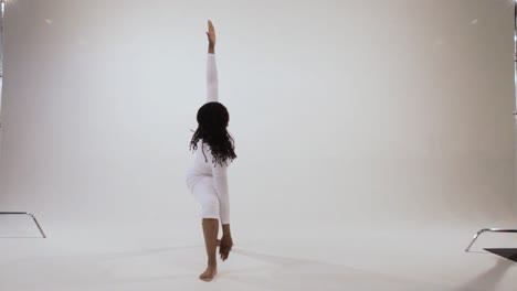 black yogini moves from warrior poses to triangle pose