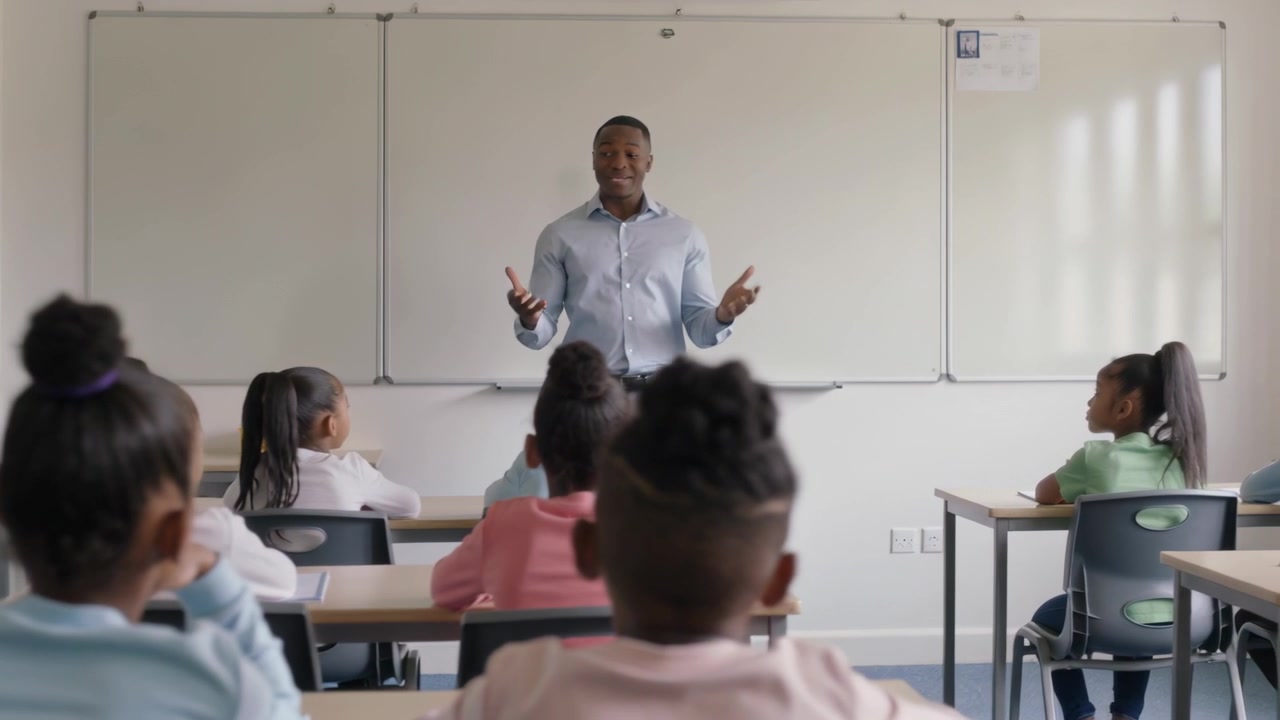 Starting teacher speaking and gesturing in class at whiteboard in blue shirt, engaging students