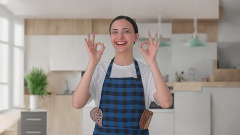 happy indian housewife showing okay sign